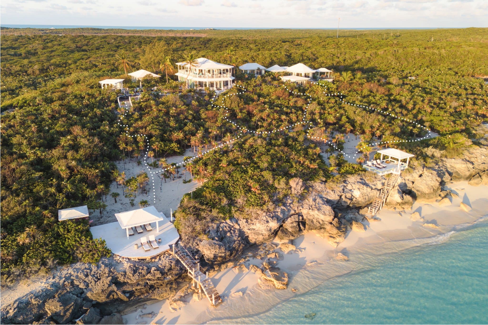 Suite at Sugar Beach Villa with ocean-facing windows and vaulted timber ceiling