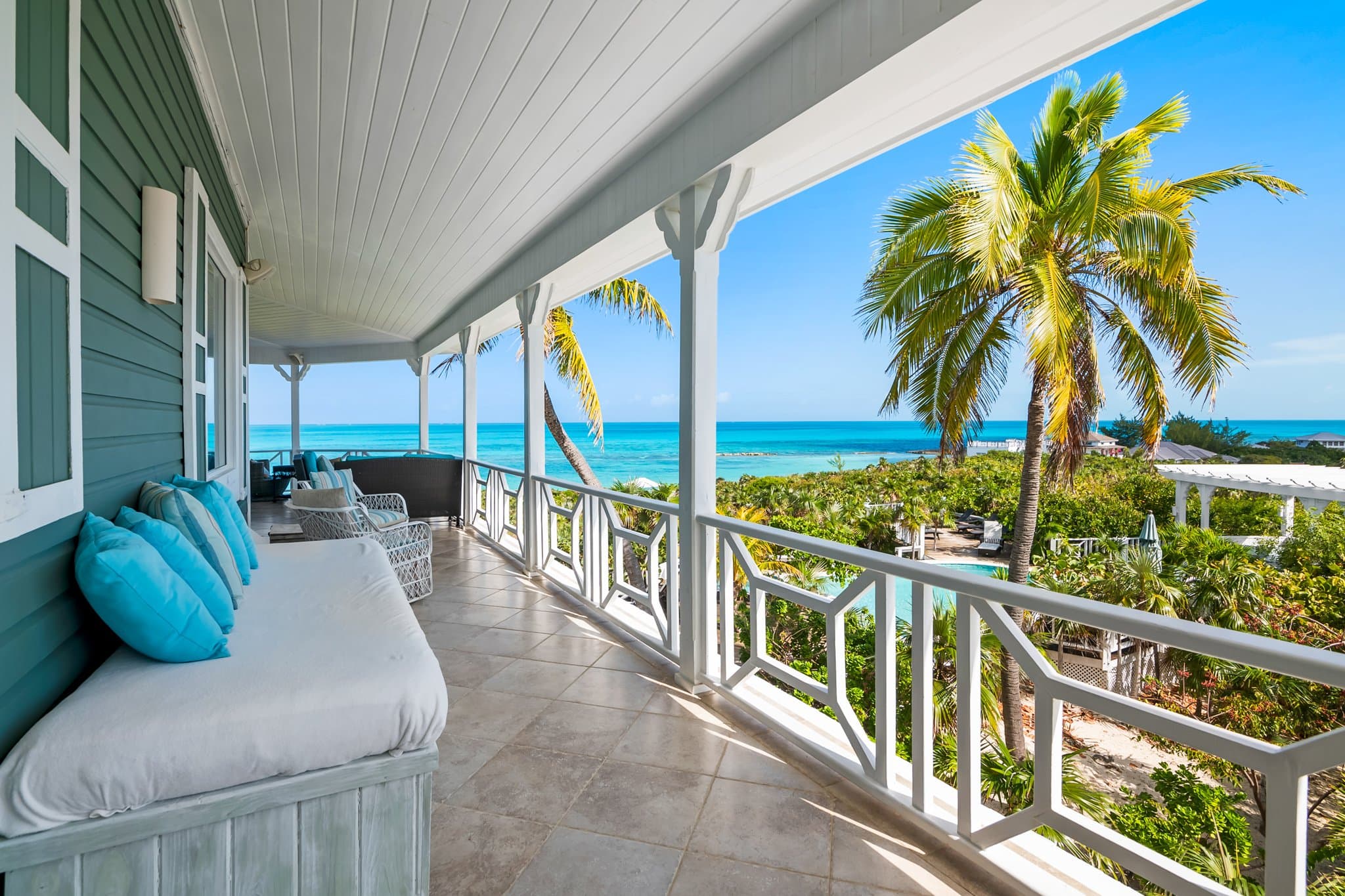 Outdoor dining deck beneath the palms at Sugar Beach Villa